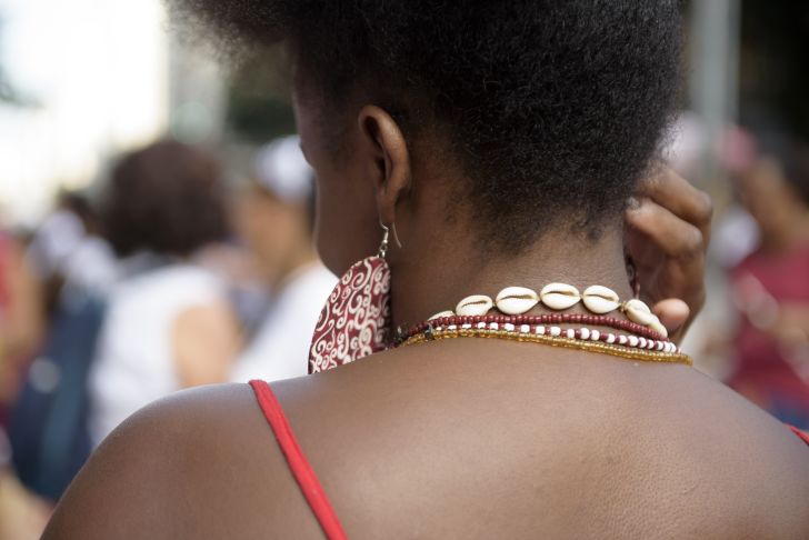 Woman wearing African jewelry viewed from the back Woman wearing African jewelry viewed from the back