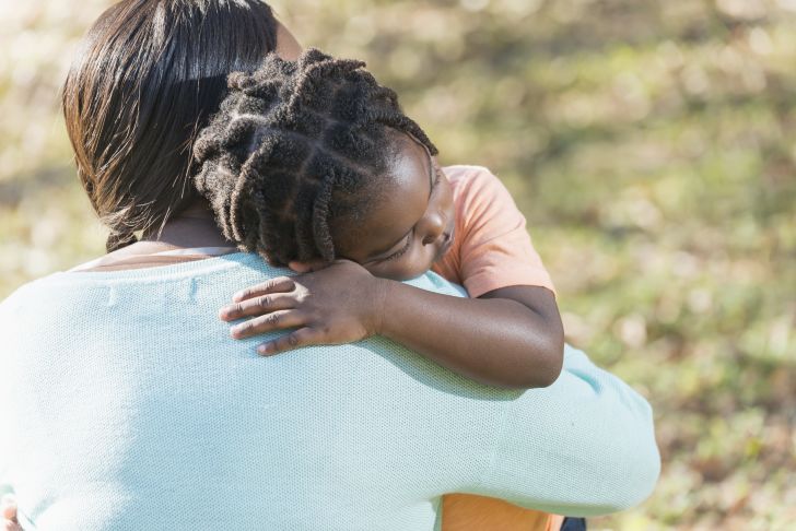 Mother holding child with a braided hairstyle Mother holding child with a braided hairstyle