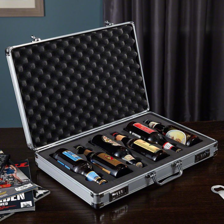 A briefcase on a desk open to reveal six beers inside