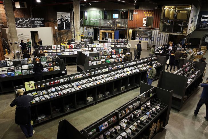 People stand on the floor of the newly opened Rough Trade NYC store on November 25, 2013 in the Brooklyn borough of New York City