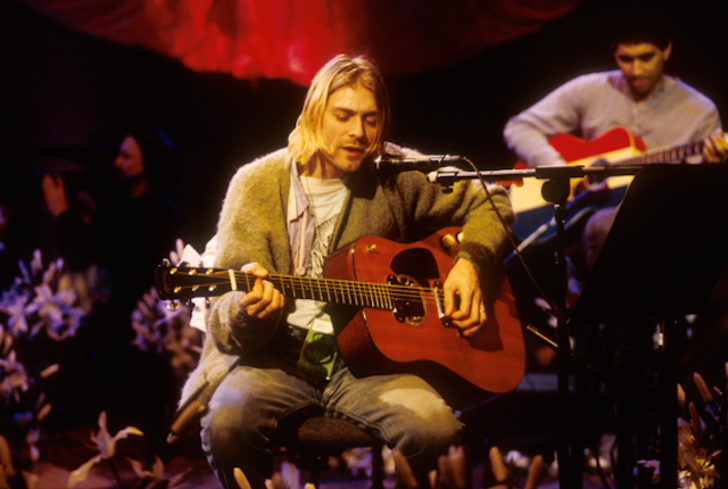 A photo of Kurt Cobain performing with Nirvana.