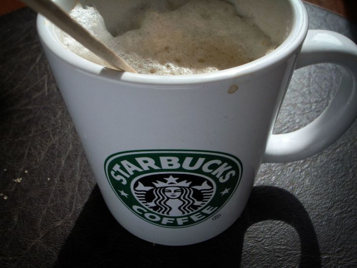 A Starbucks coffee cup is seen in close-up