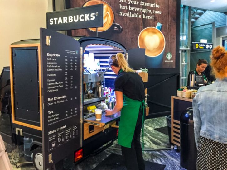 A Starbucks employee prepares an order