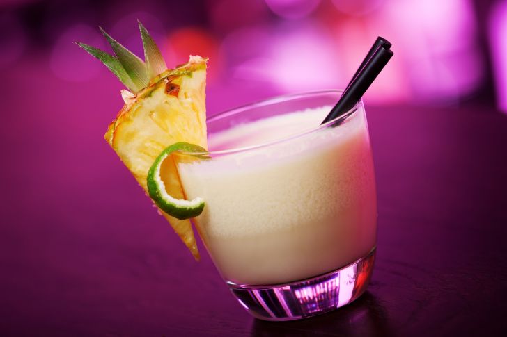 A piña colada against a purple background