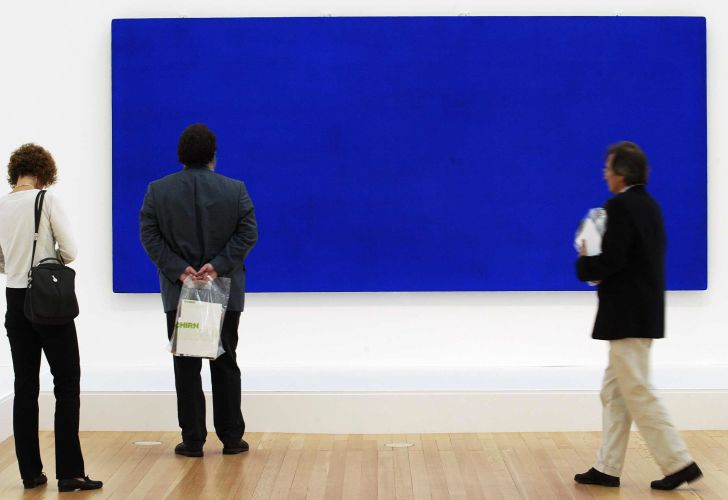 Visitors look at 'Monochrome Blue, without title' (1960) by French artist Yves Klein