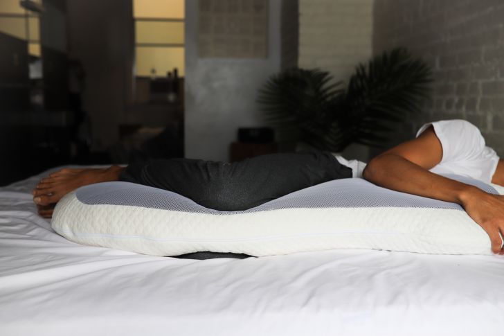 Person sleeping with body pillow.