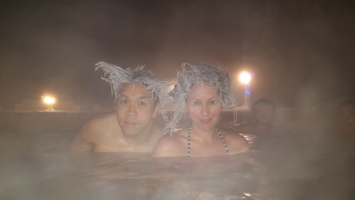 People with frozen hair in hot tub.