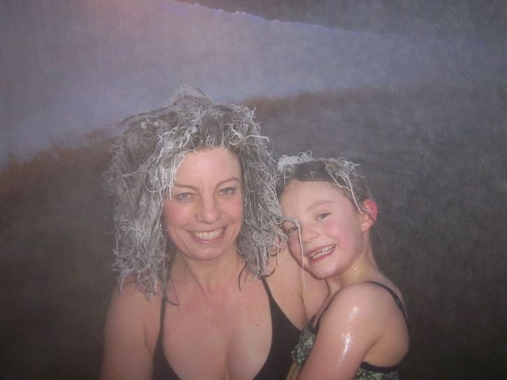 People with frozen hair in hot tub.