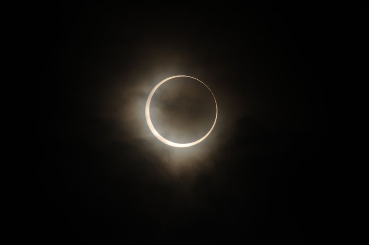 Moon covering sun during solar eclipse.