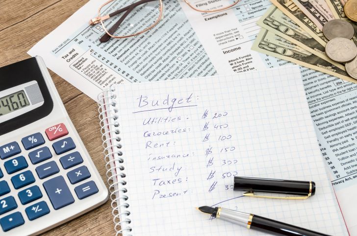 A handwritten budget in a notebook