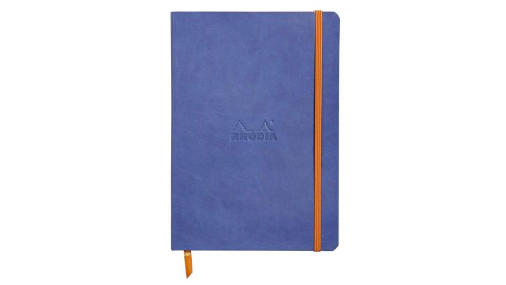 A periwinkle blue notebook with an orange elastic band