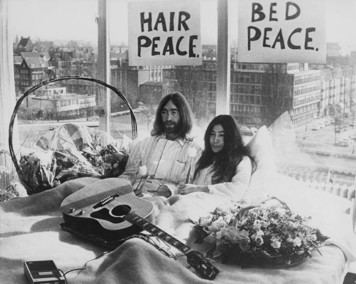 John Lennon and Yoko Ono in their bed in the Presidential Suite of the Hilton Hotel, Amsterdam, 25th March 1969. The couple are staging a 'bed-in for peace' and intend to stay in bed for seven days 'as a protest aga