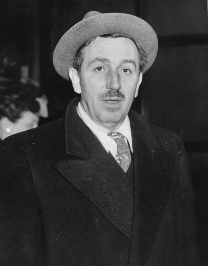 Cartoonist and film producer Walt Disney (1901 - 1966) arriving in the foyer of a London hotel
