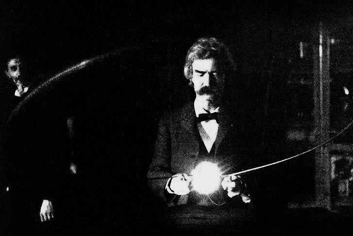 A photograph of Mark Twain holding a vacuum lamp, with Nikola Tesla in the background