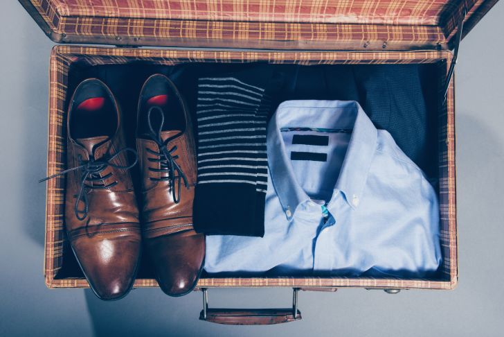 A suitcase with men's clothing inside