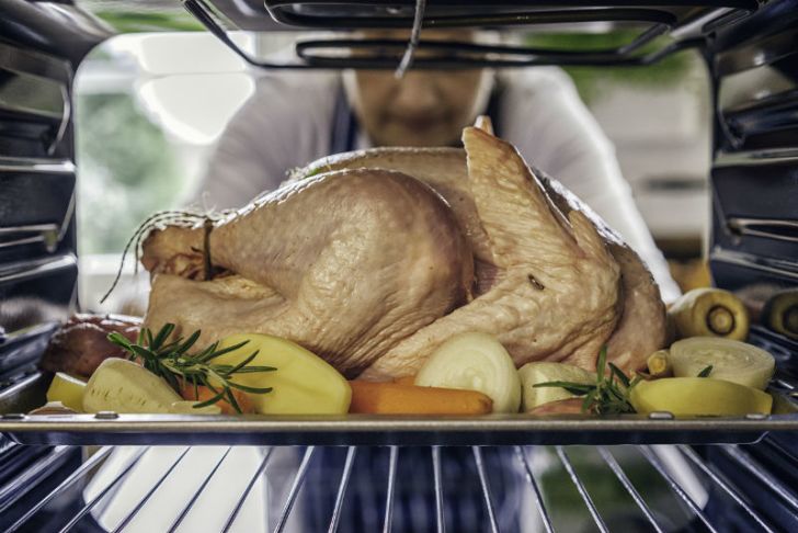 A turkey is placed into an oven