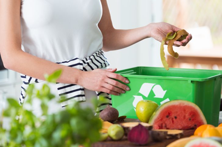 Woman composting organic kitchen waste Woman composting organic kitchen waste