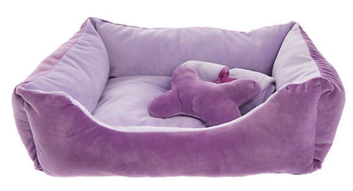 A pillow and blanket sit inside a Grreat Choice Hash Cuddler pet bed