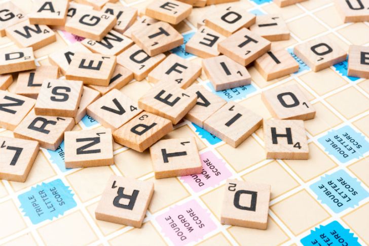 Scrabble tiles are scattered across the board