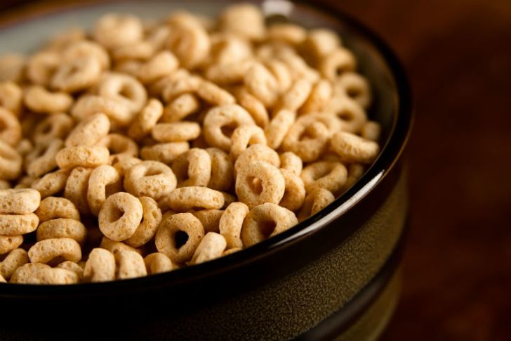 A bowl of Cheerios sits on a table
