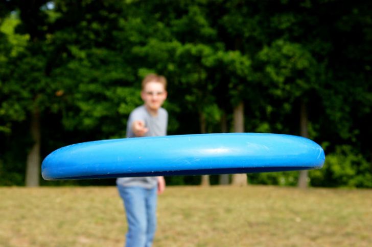 A man throws a Frisbee at the camera