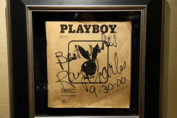 A Braille edition of 'Playboy' signed by Ray Charles hangs on a wall
