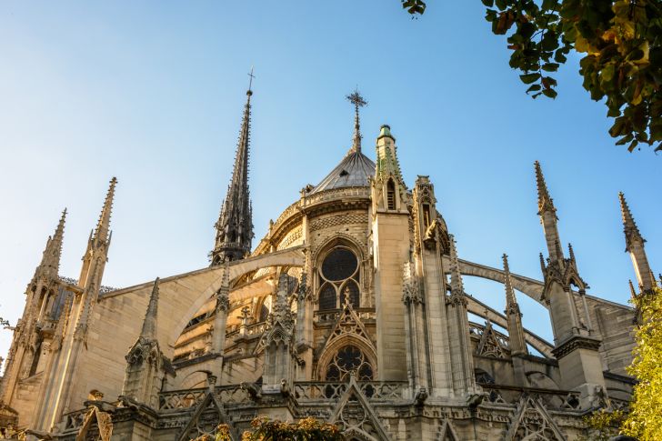 Low angle view of the East end of Notre-Dame de Paris cathedral at sunset with flying buttresses