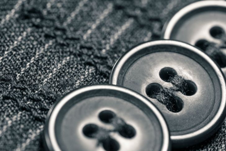 Buttons are seen on a sleeve in close-up