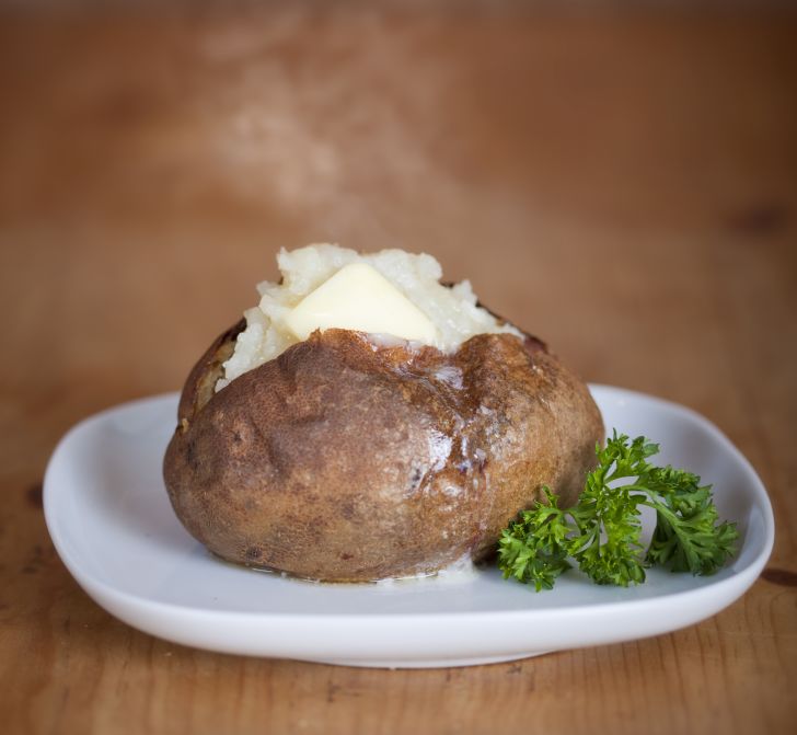 Baked potato on plate.