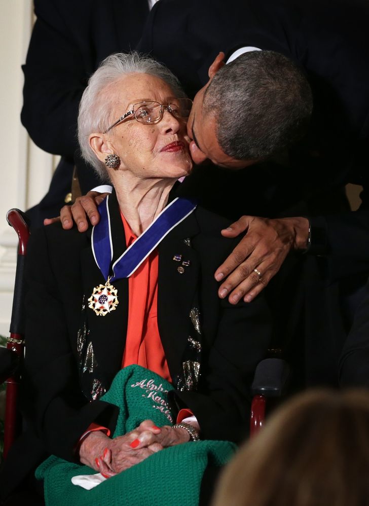 U.S. President Barack Obama kisses former NASA mathematician Katherine G. Johnson after he presented her with the Presidential Medal of Freedom during an East Room ceremony November 24, 2015 at the White House
