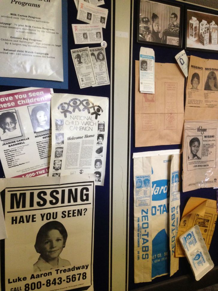 A number of missing-child posters hang on a wall
