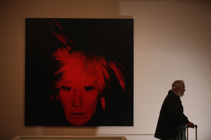 A visitor walks near Self-Portrait 1986 by artist Andy Warhol (1928-1987) at the Graves Gallery on April 11, 2012 in Sheffield, England