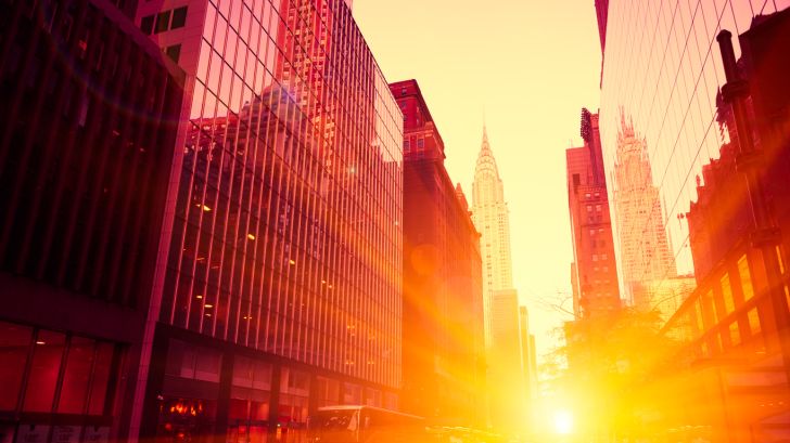 sunlight shining through city streets and buildings