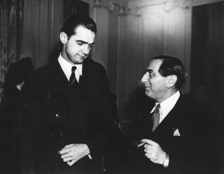 image of Howard Hughes standing next to some other guy