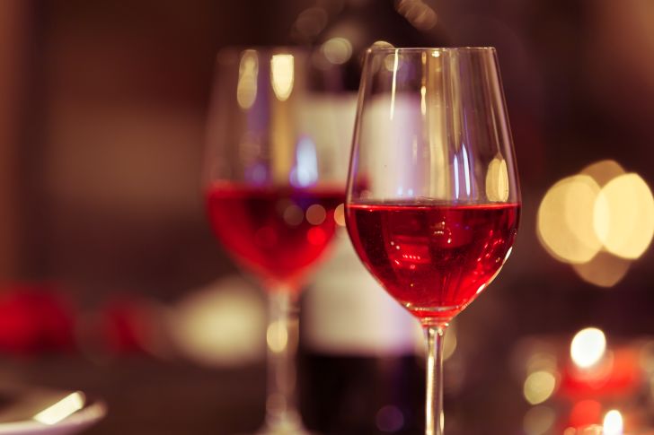 image of wine glasses filled with red champagne