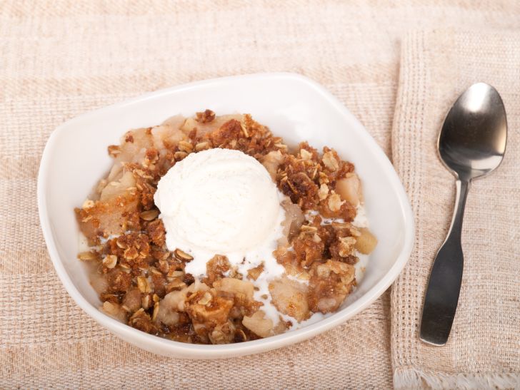 image of vanilla ice cream sitting on top of a bowl of what could be cereal, but probably isn't