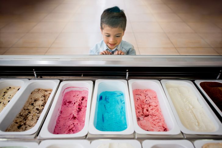 image of a child looking at the flavors inside an ice cream counter