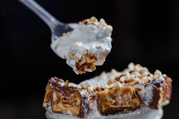 image of soft serve ice cream with Snickers bars mixed inside