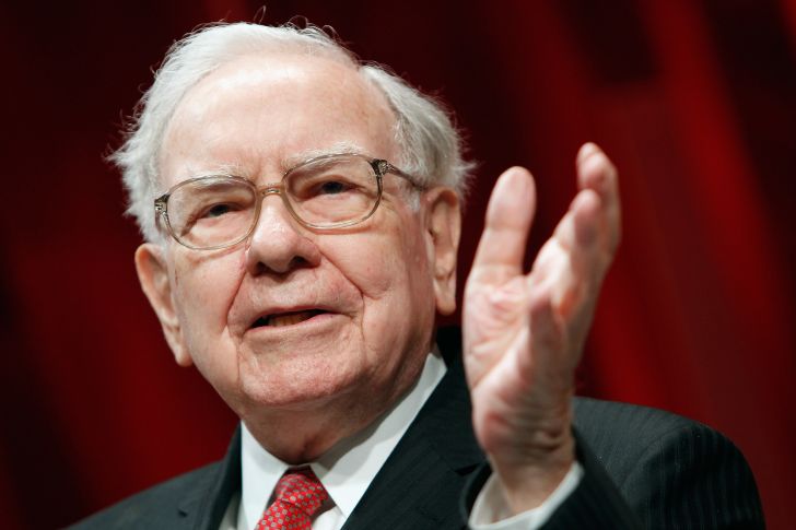 image of Warren Buffett gesturing toward an audience