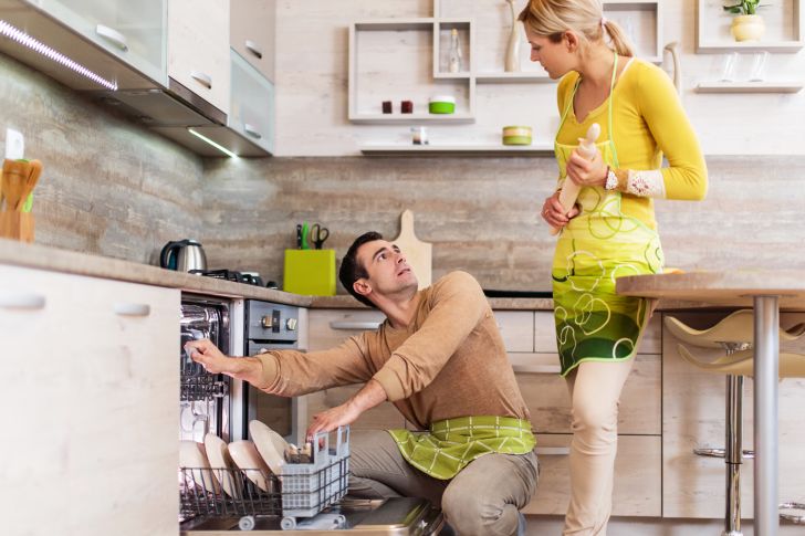 A couple arguing in their kitchen