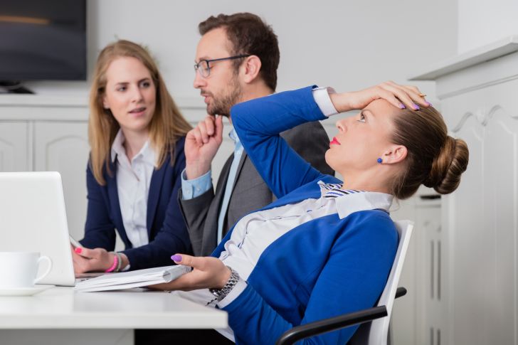 A woman looking frustrated at work