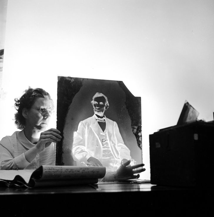 A researcher holding one of America's most priceless negatives, the glass plate made by famous civil war photographer Mathew Brady of Abraham Lincoln in 1865 just before he was assassinated.
