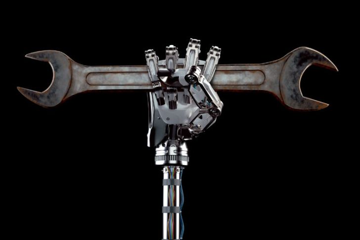 A robot arm holds up a wrench