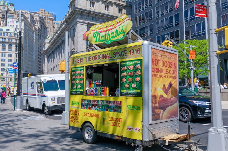 Image of a Nathan's Famous food cart on a street in New York City