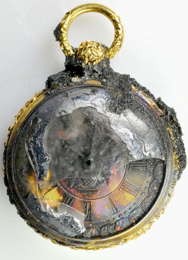 A close-up of the gold pocket watch