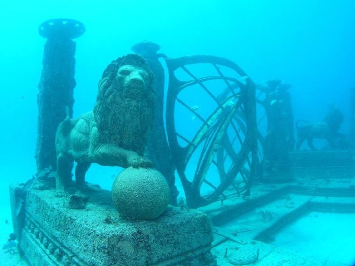 An underwater lion sculpture and other memorials