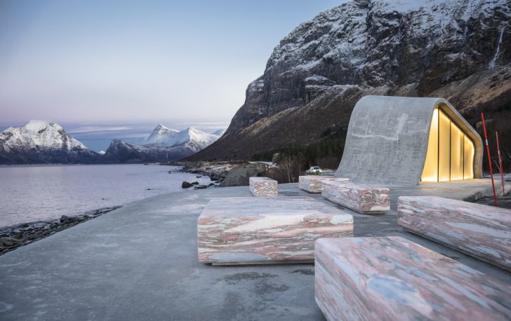 Bench seating outside the restroom, with mountains in the background