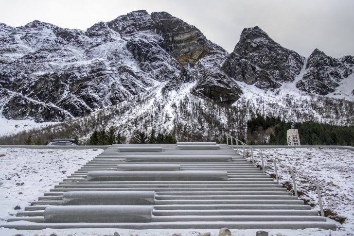 A view up the stairs of the amphitheater toward steep mountains