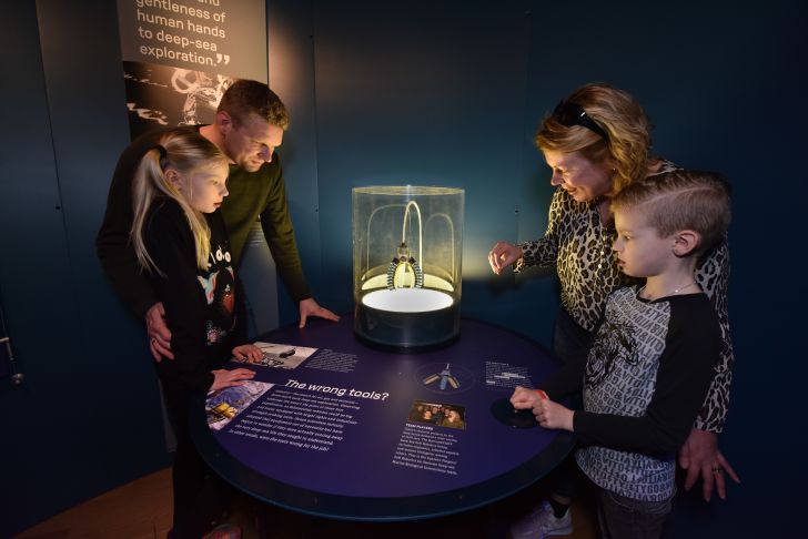 Family looking at museum exhibit