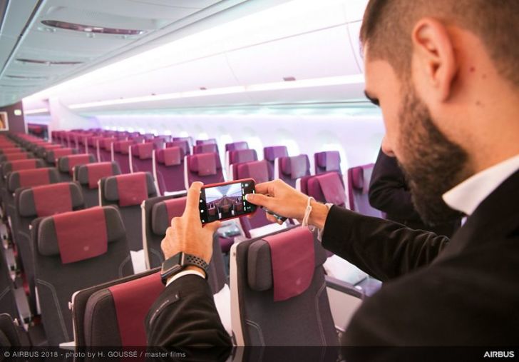 A journalist takes a photo of the A350-1000 cabin